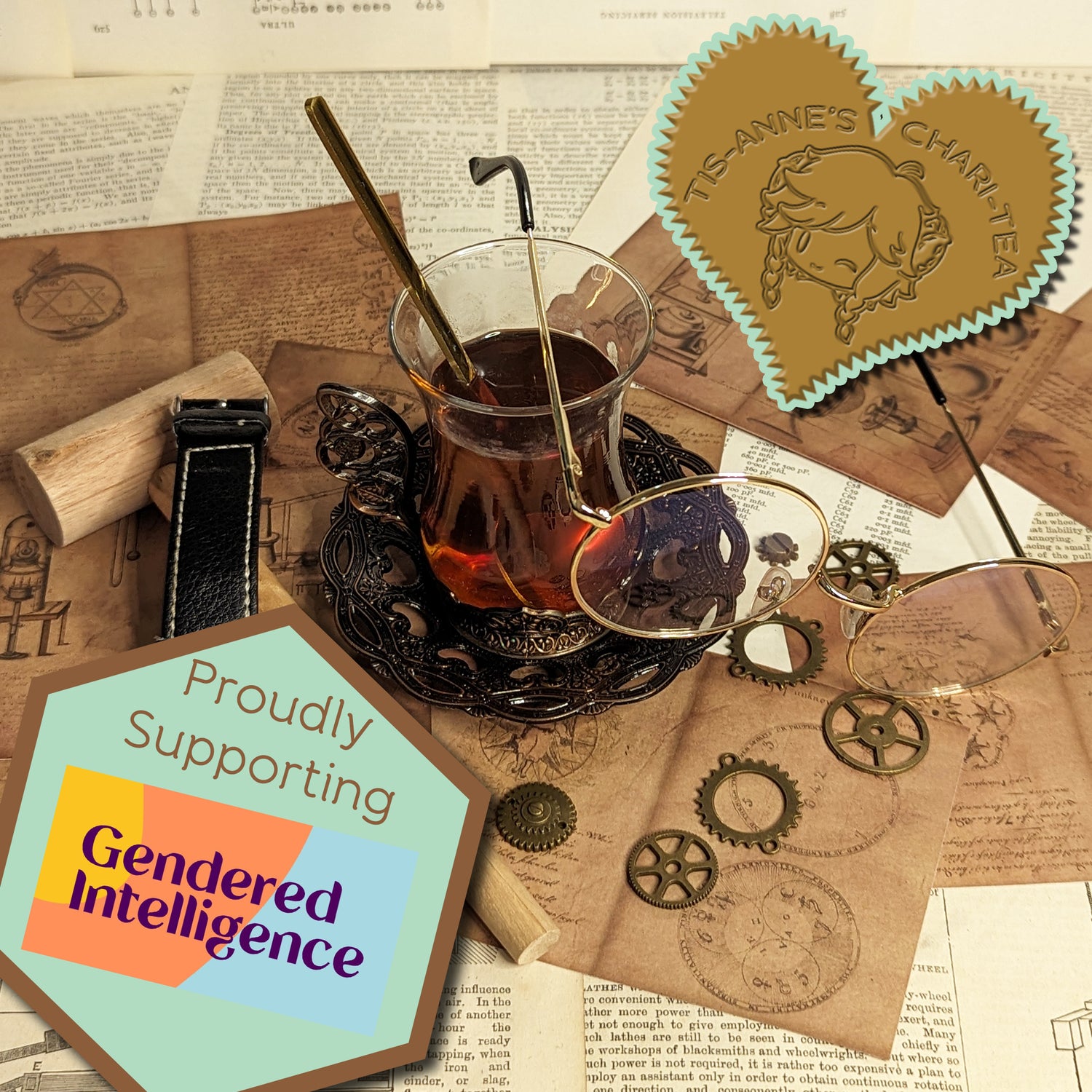 A tall, glass cup of tea and a wrought-iron dish are on top of sheets of paper covered in alchemical and engineering designs.
A heart-shaped badge in one corner reads "Tis-Anne's Chari-Tea", and an emblem in the other reads "Proudly Supporting Gendered Intelligence"
