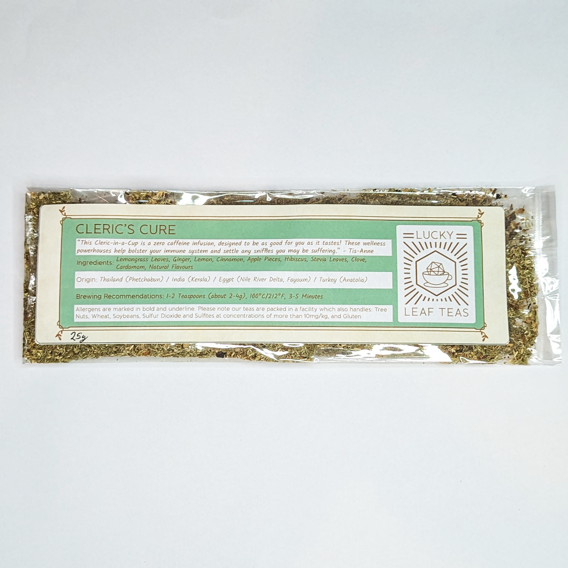 A slim, see-through package containing 25g of Cleric’s Cure: a herbal infusion blend. A label with the name, ingredients, origin and brewing recommendations is printed on the front, next to the Lucky Leaf Teas Logo.