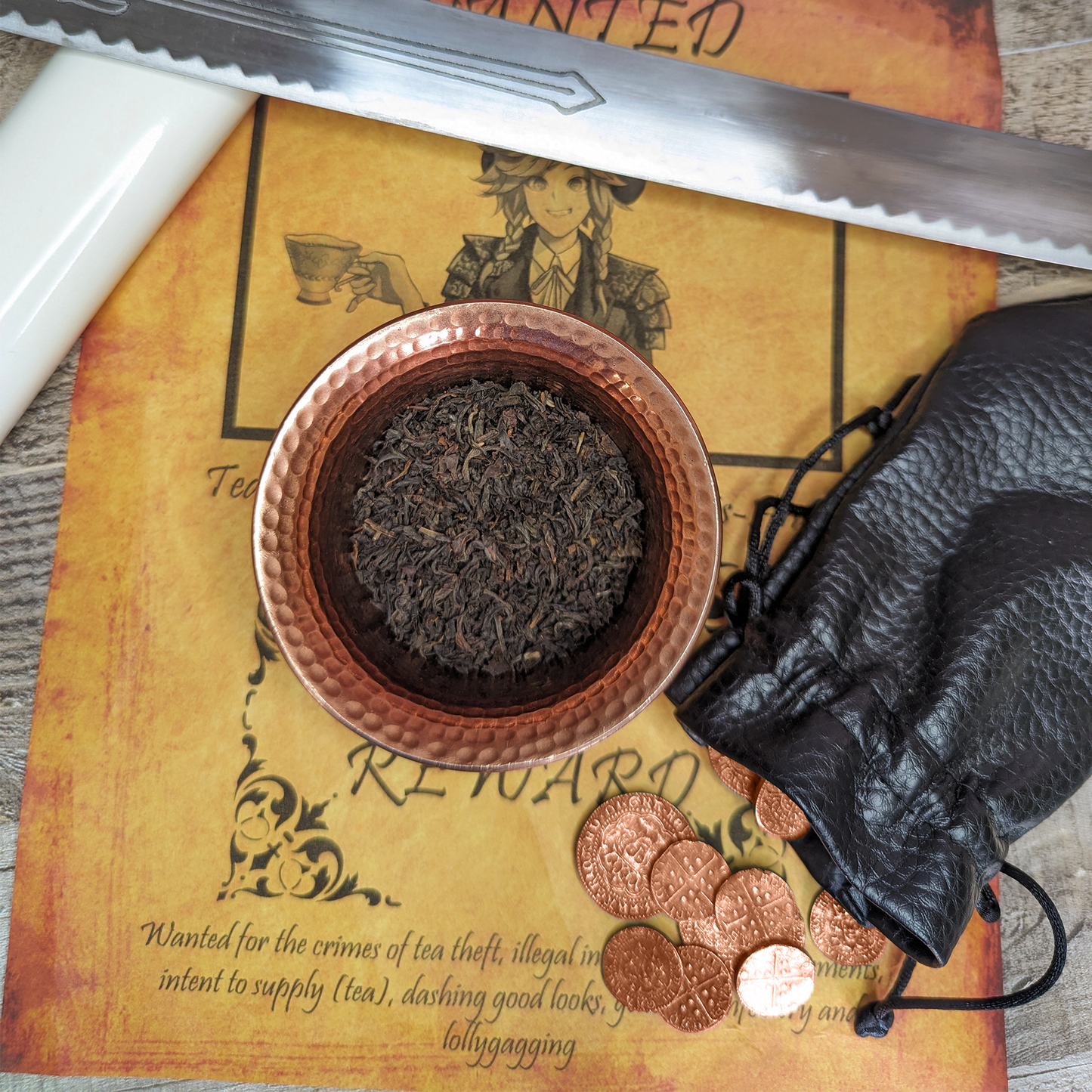 A copper bowl filled with curled, black tea leaves, with flecks of light brown tips blended in.