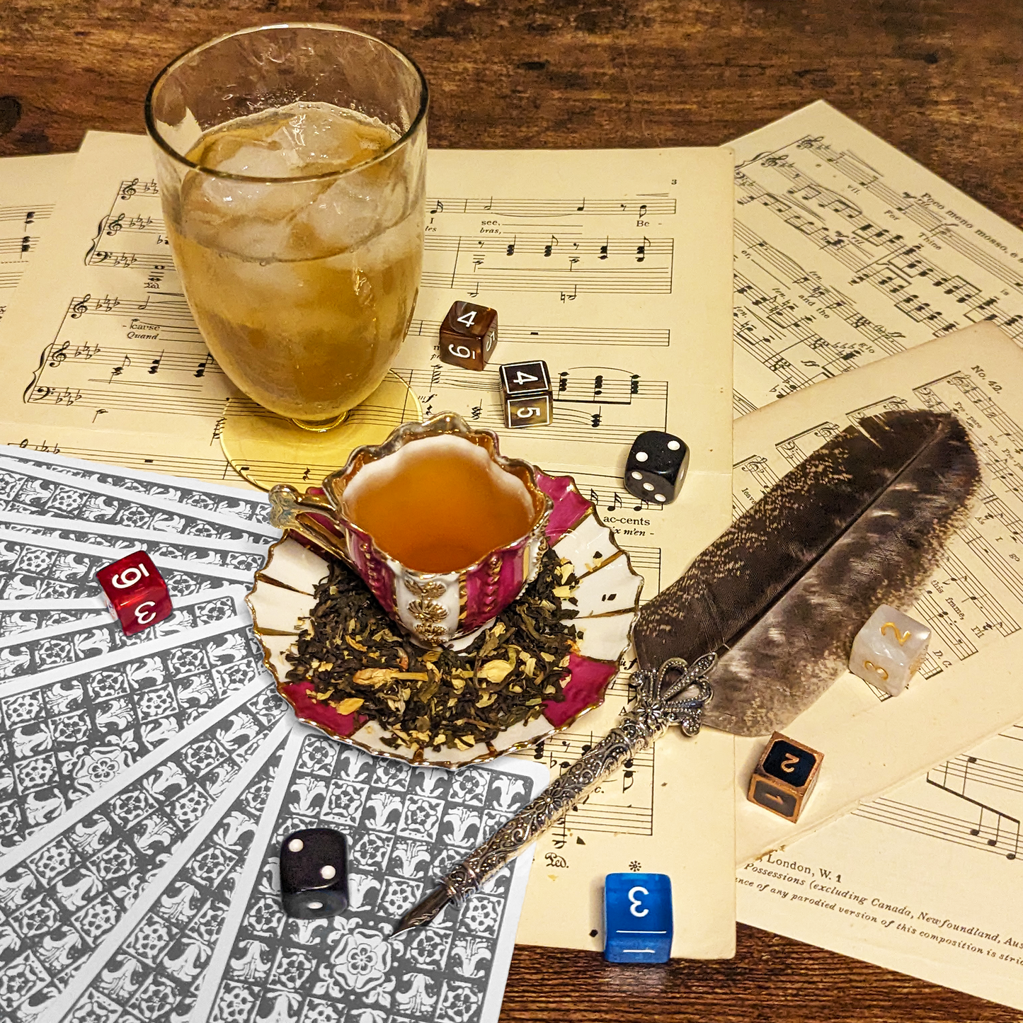 A striped teacup filled with yellow-orange tea, surrounded by a mound of tea leaves and six-sided dice.